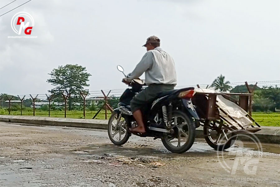 A motorbike sidecar driver in Sittwe is pictured in June 2023.